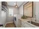 Functional laundry room features washer and dryer, shelving, a sink, and ample counter space at 4465 Newhall Dr, Cumming, GA 30040