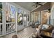 Inviting screened porch with comfortable wicker furniture and views of the outdoors at 4465 Newhall Dr, Cumming, GA 30040