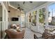 Relaxing screened porch with wicker furniture and ceiling fan at 4465 Newhall Dr, Cumming, GA 30040