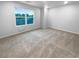 Bright, unfurnished bedroom with plush carpet and natural light from a large window at 1112 Highwood Ln, Atlanta, GA 30344