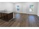 Unfurnished living room and kitchen area with hardwood style floors and natural lighting at 1112 Highwood Ln, Atlanta, GA 30344