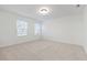A bedroom features two windows that let natural light illuminate the clean and minimalist aesthetic at 2107 Stillhaven Pl, Douglasville, GA 30135