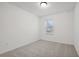 A brightly-lit bedroom features neutral carpet, white walls, and a sunny window at 2107 Stillhaven Pl, Douglasville, GA 30135