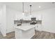 Modern kitchen featuring white cabinets, center island, stainless steel appliances, and pendant lights at 2107 Stillhaven Pl, Douglasville, GA 30135