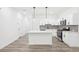 Bright modern kitchen featuring a center island, white cabinetry, and stainless steel appliances at 2107 Stillhaven Pl, Douglasville, GA 30135