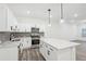 Modern kitchen with a spacious island, pendant lighting, and stainless steel appliances at 2107 Stillhaven Pl, Douglasville, GA 30135