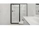 A new bathroom with a glass-enclosed shower features built-in shelves for added convenience at 2107 Stillhaven Pl, Douglasville, GA 30135