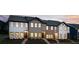 Exterior view of newly built townhomes with varied facades and professionally landscaped yards at 2107 Stillhaven Pl, Douglasville, GA 30135