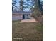 Backyard area showcases a concrete patio, trash bins, a gray house, and green grass at 2335 Boulder Se Rd, Atlanta, GA 30316