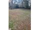 A backyard features grass, trees, and natural surroundings, ideal for outdoor activities at 2335 Boulder Se Rd, Atlanta, GA 30316