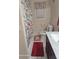 Cozy bathroom with a floral shower curtain, vanity, and tiled flooring at 2335 Boulder Se Rd, Atlanta, GA 30316
