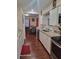 Open kitchen design with white cabinets, stainless steel appliances, and laminate wood flooring at 2335 Boulder Se Rd, Atlanta, GA 30316