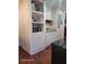 Efficient kitchen space with white cabinetry, appliances, and laminate wood flooring at 2335 Boulder Se Rd, Atlanta, GA 30316