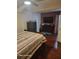 Main bedroom features a comfortable bed, hardwood floors, and a TV, offering a relaxing retreat at 2335 Boulder Se Rd, Atlanta, GA 30316
