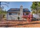 Rear elevation showcasing a cozy deck and neutral siding, seamlessly blending indoor and outdoor living at 3110 Chandon Ln, Lawrenceville, GA 30044