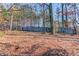 The home features a expansive backyard partially surrounded by a traditional wooden fence at 3110 Chandon Ln, Lawrenceville, GA 30044