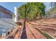 View of the backyard of a two-story home, complete with a deck and lots of mature trees at 3110 Chandon Ln, Lawrenceville, GA 30044