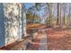 Side yard with a stone path leading to a wooded backyard at 3110 Chandon Ln, Lawrenceville, GA 30044