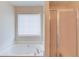 Bathroom features a soaking tub with jets and a separate shower stall at 3110 Chandon Ln, Lawrenceville, GA 30044