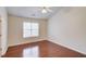 Neutral bedroom with a ceiling fan and large window that provides lots of natural light at 3110 Chandon Ln, Lawrenceville, GA 30044