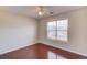Well-lit bedroom featuring hardwood floors, a ceiling fan, and a bright window at 3110 Chandon Ln, Lawrenceville, GA 30044