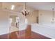 Open dining room with hardwood floors adjacent to a bright, modern kitchen at 3110 Chandon Ln, Lawrenceville, GA 30044