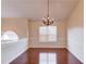 Dining room featuring hardwood floors, a chandelier, and a large window for natural light at 3110 Chandon Ln, Lawrenceville, GA 30044