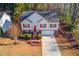 Aerial view of a two-story home with a well-manicured lawn, red shutters, and a brick-accented front at 3110 Chandon Ln, Lawrenceville, GA 30044