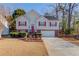 Charming two-story home with a well-manicured lawn, red shutters, and a brick-accented front at 3110 Chandon Ln, Lawrenceville, GA 30044