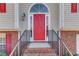 A vibrant red front door framed by brick steps and a decorative window above at 3110 Chandon Ln, Lawrenceville, GA 30044