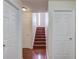 Hallway featuring hardwood floors, a staircase, and white doors at 3110 Chandon Ln, Lawrenceville, GA 30044