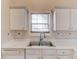 The kitchen features a stainless steel double sink, white cabinets, and wood blinds at 3110 Chandon Ln, Lawrenceville, GA 30044