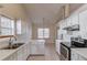 Bright kitchen featuring stainless appliances, white cabinets, and tile floors at 3110 Chandon Ln, Lawrenceville, GA 30044