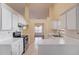 Bright kitchen featuring white cabinets, tile backsplash, and stainless steel appliances at 3110 Chandon Ln, Lawrenceville, GA 30044