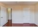 Bright interior room featuring hardwood floors and white doors with gold hardware at 3110 Chandon Ln, Lawrenceville, GA 30044