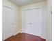 A room featuring hardwood floors, a closet with double doors, and a white door at 3110 Chandon Ln, Lawrenceville, GA 30044