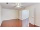 A bright room featuring hardwood floors, a ceiling fan, and white doors at 3110 Chandon Ln, Lawrenceville, GA 30044