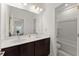 Bright bathroom with double sink vanity, large mirror, and glass-enclosed shower at 355 Walker Avenue, Roswell, GA 30076