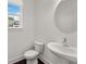Stylish half bathroom with white pedestal sink and mirror at 355 Walker Avenue, Roswell, GA 30076