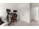 Bright bedroom featuring a chair, an adjustable desk with dual monitors, closet and doorway at 355 Walker Avenue, Roswell, GA 30076