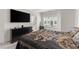 Bedroom with a large window, TV, dresser, and stylish patterned bedspread at 355 Walker Avenue, Roswell, GA 30076