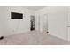 Bedroom with neutral carpet, black tv, white walls and a view of the staircase at 355 Walker Avenue, Roswell, GA 30076