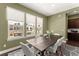 Dining area with large table, modern chairs, and natural light from the three windows at 355 Walker Avenue, Roswell, GA 30076