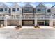 Picturesque view of multiple townhomes featuring garages and outdoor balconies enhancing the community's appeal at 355 Walker Avenue, Roswell, GA 30076