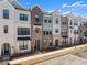 View of townhomes featuring a brick and siding facade, black trim, and an accessible sidewalk at 355 Walker Avenue, Roswell, GA 30076