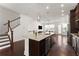 Open-concept kitchen with granite island, stainless appliances, and access to the living area at 355 Walker Avenue, Roswell, GA 30076