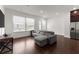 Open-concept living room with hardwood floors, modern sofa, and stainless steel appliances at 355 Walker Avenue, Roswell, GA 30076