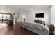 Inviting living room with hardwood floors, modern sofa, and open layout to dining area at 355 Walker Avenue, Roswell, GA 30076