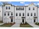 Inviting townhomes featuring white exteriors, black door accents, and meticulously landscaped front yards at 3162 Washburn Sw St, Atlanta, GA 30354