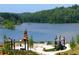 Lakeside view featuring a gazebo, fireplace, and lush green trees at 318 Sandy Springs Cir # 220, Sandy Springs, GA 30328
